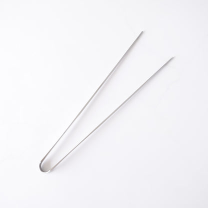 Stainless steel tongs on a white background