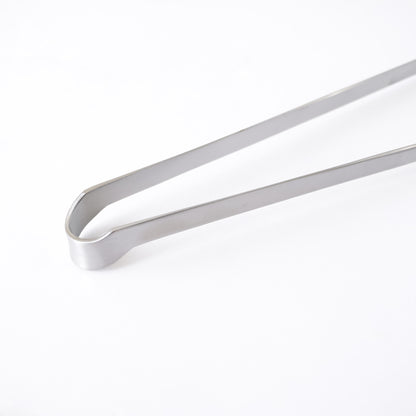 Metallic tongs on a white background