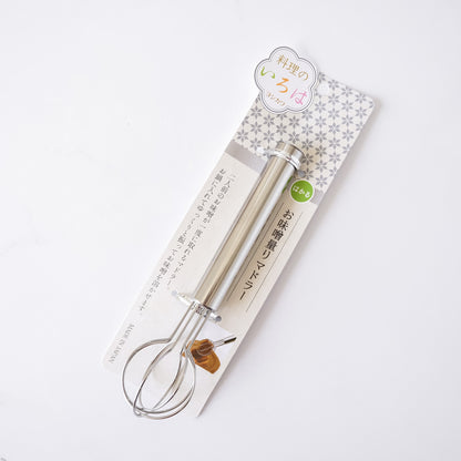 Metal whisk on a branded packaging with Japanese text