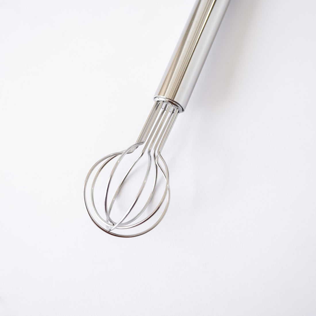 Metallic whisk on a white background