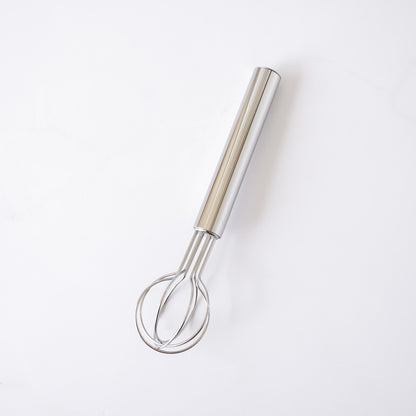 Metallic whisk on a white background