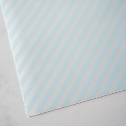 Sheet of paper with blue diagonal stripes on a light gray background