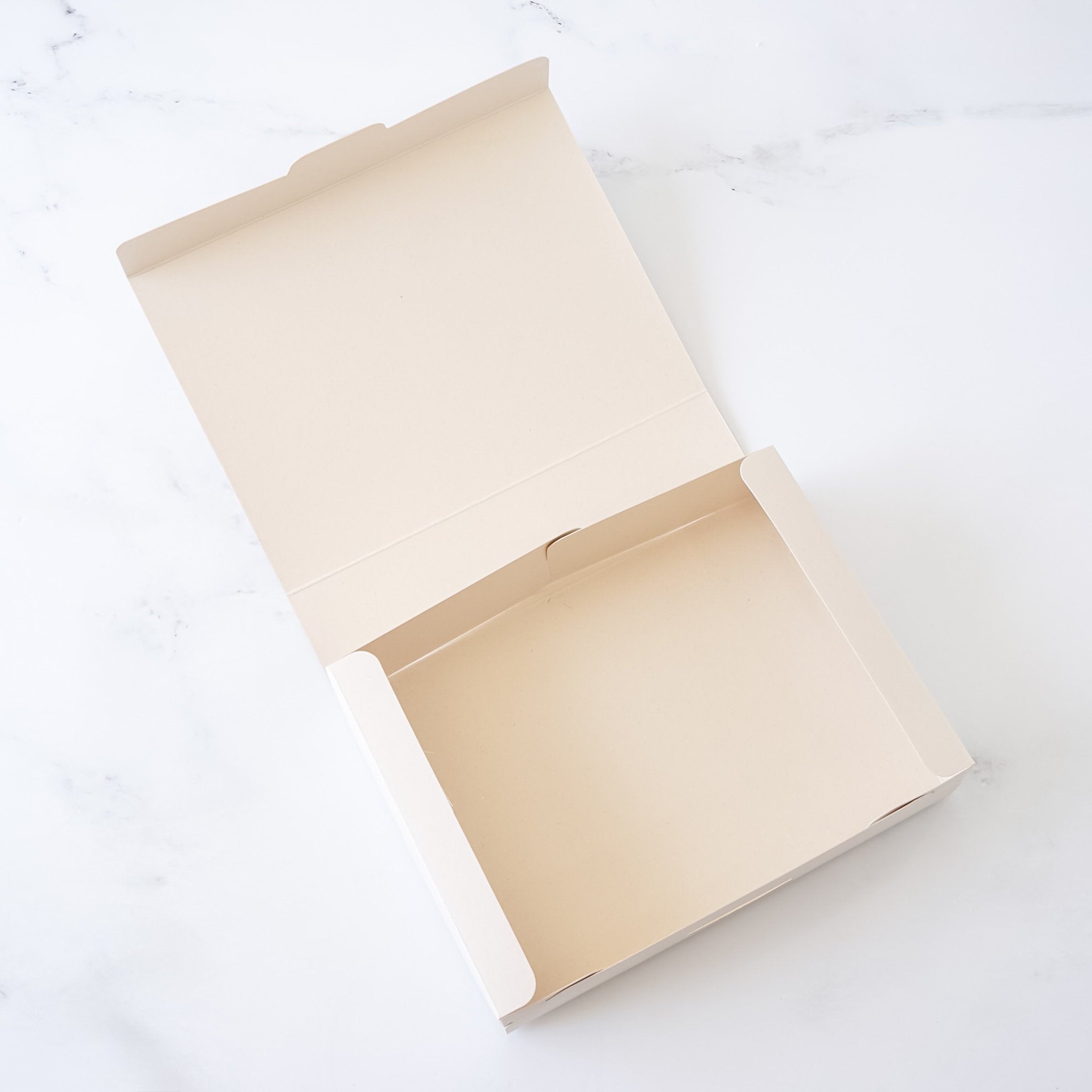 Open beige cookie box on a white background