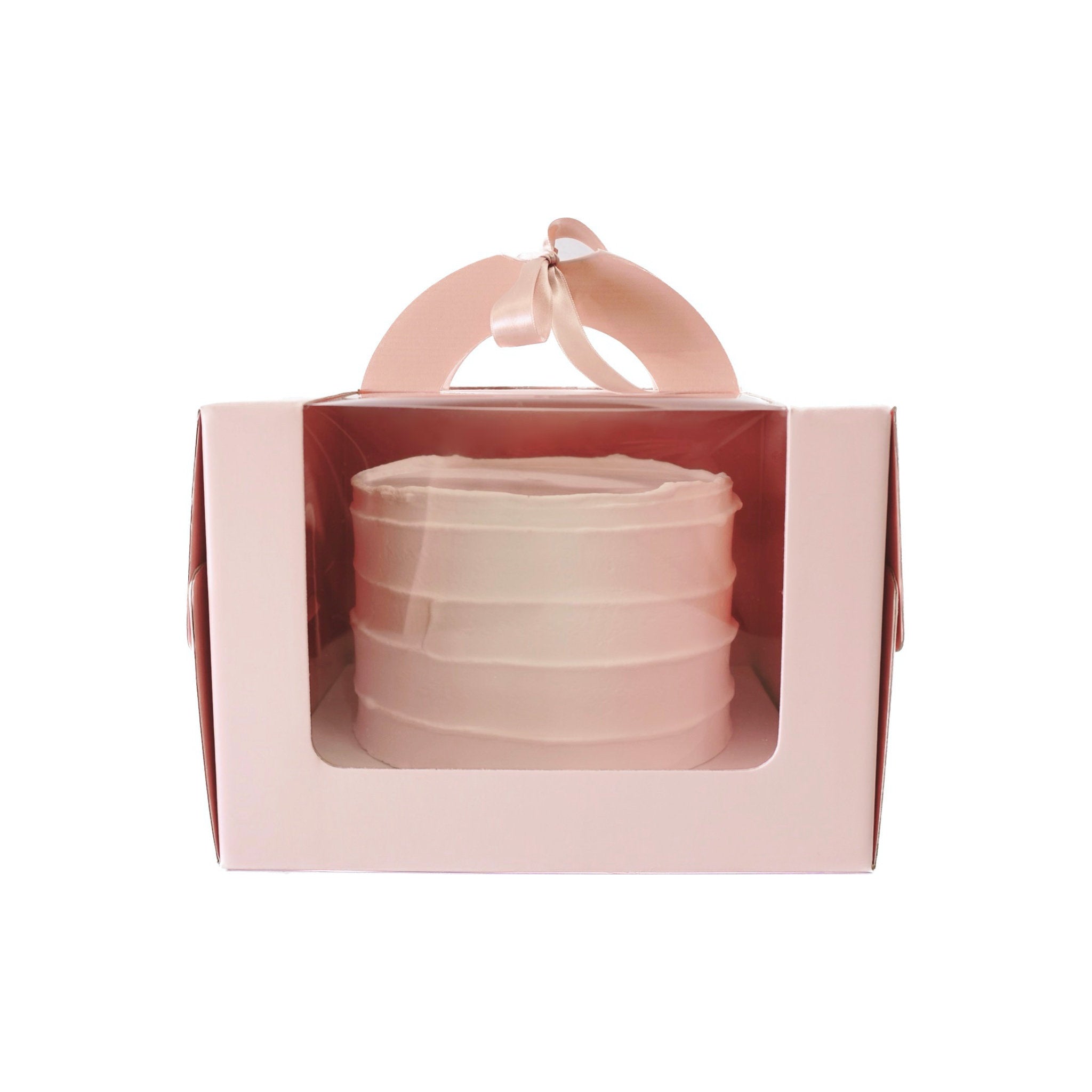A pink and clear plastic cake box with a handle and a pink ribbon. The box has a clear window on the front to display the cake inside.