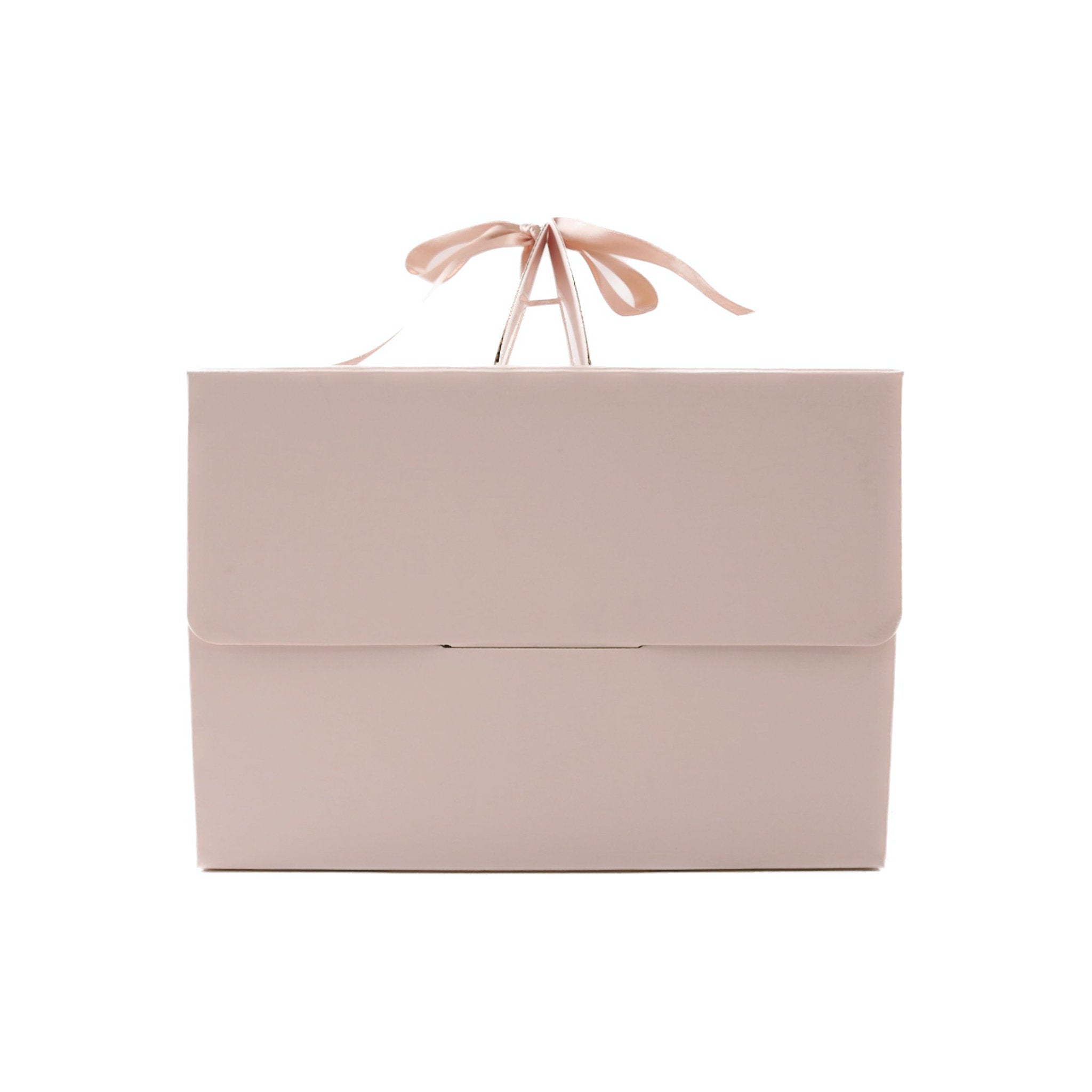 A light pink gift box with a satin ribbon tied around the handle.
