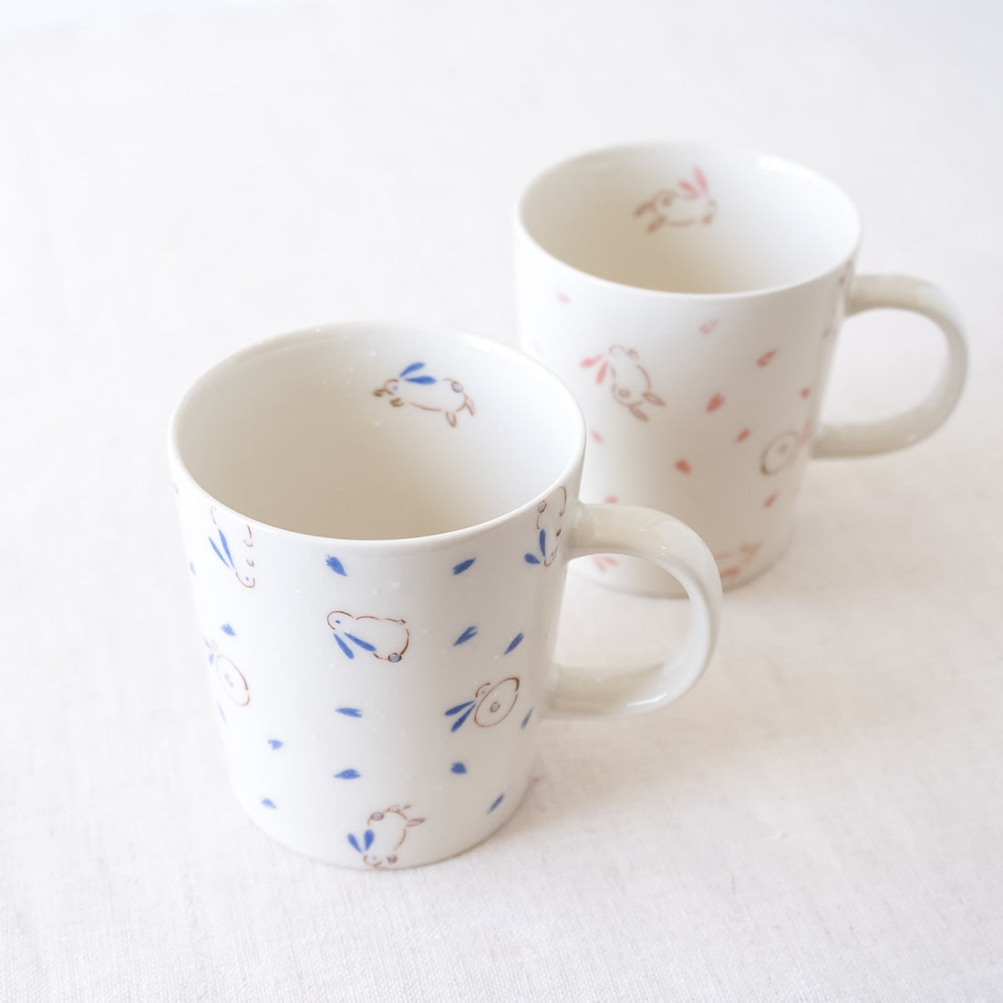 bouncing bunny mugs in pink, blue