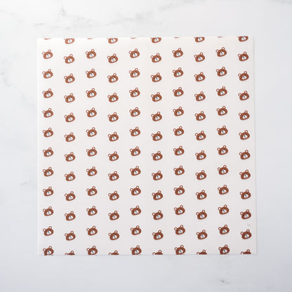 White paper with brown bear pattern on a white background