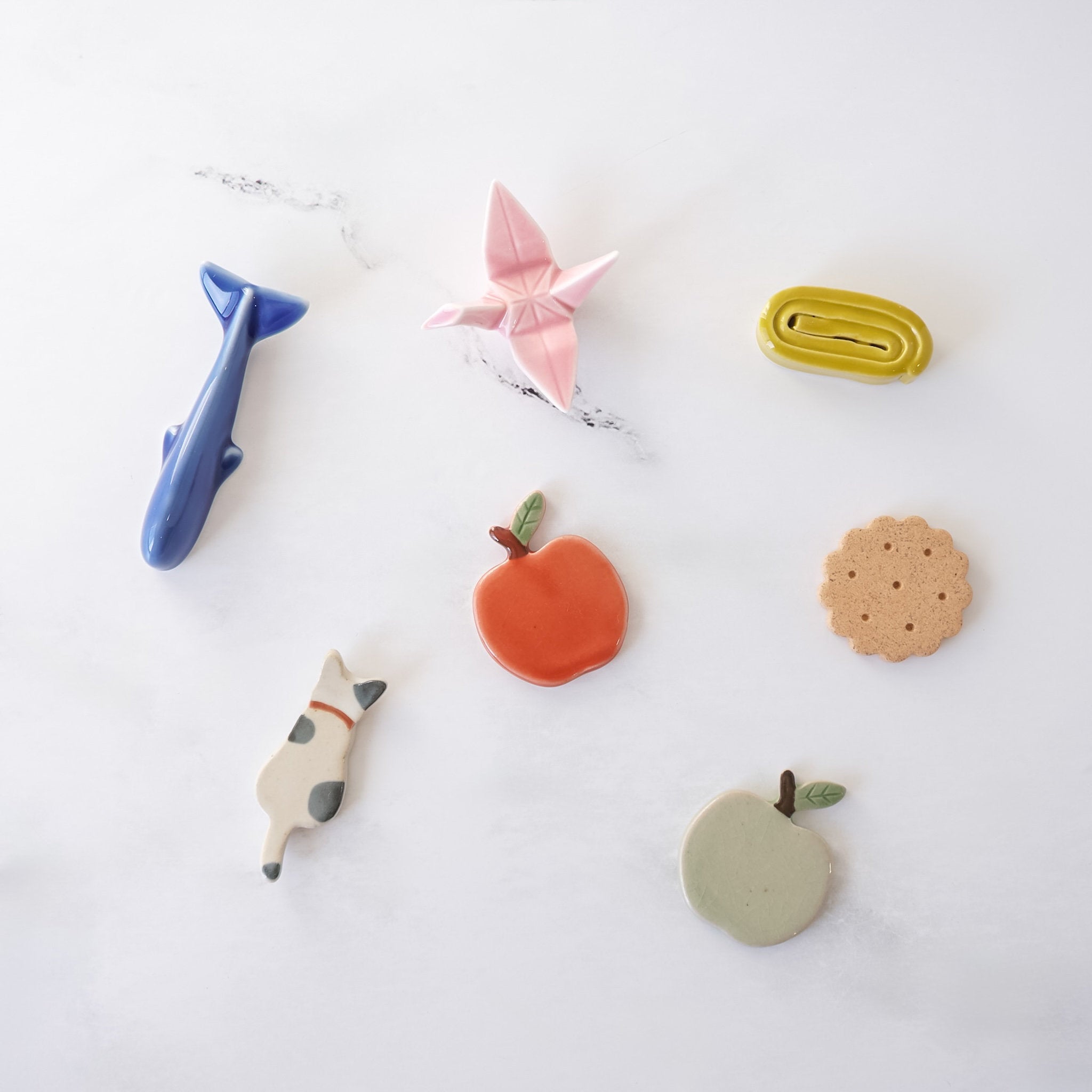Collection of colorful chopstick rests on a white background
