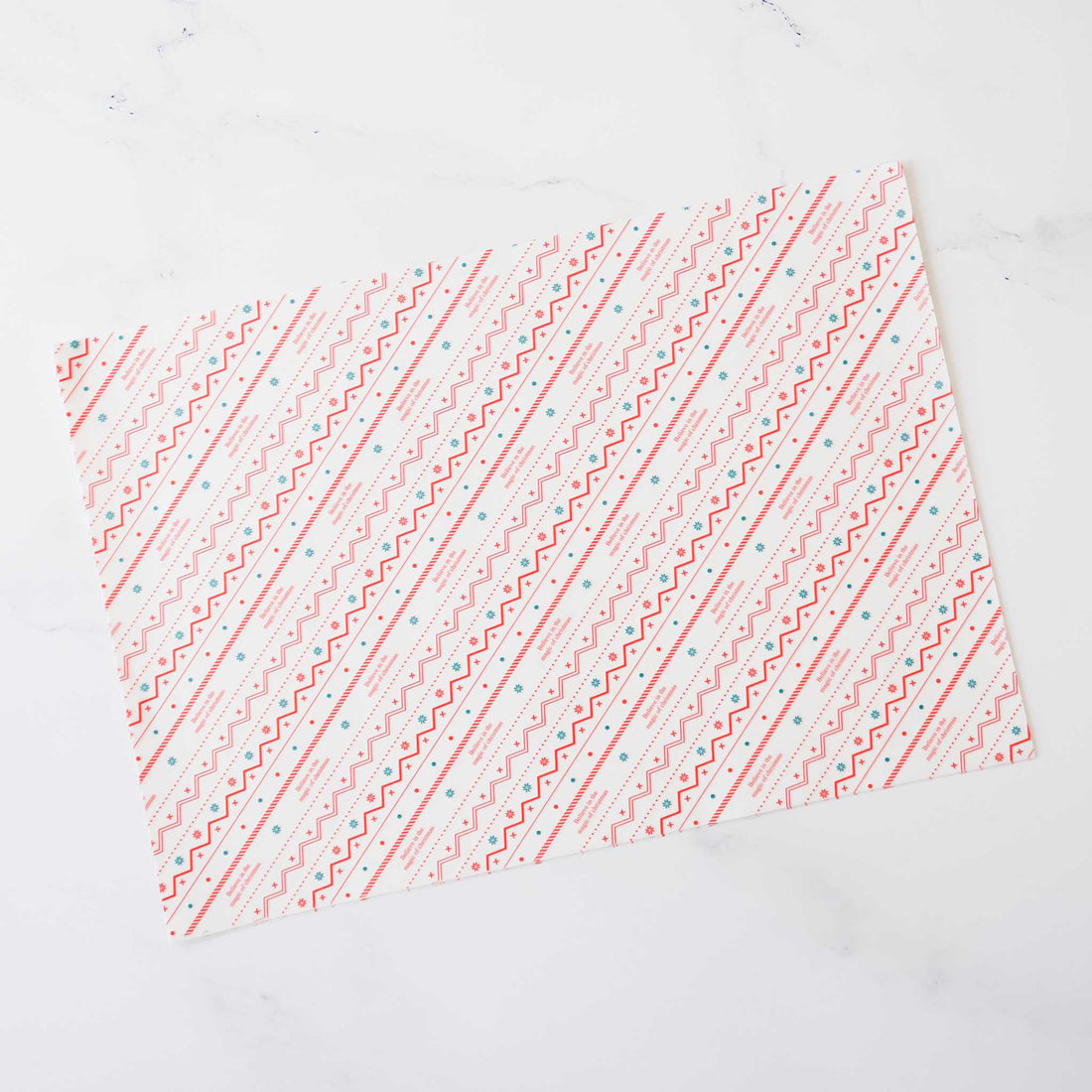 Pink and teal geometric patterned wrapping paper. The design features diagonal lines of repeating zigzags and dots on a white background. This decorative paper is ideal for gift wrapping and crafting projects.