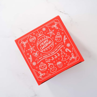Red square Christmas gift box with a white line art design. The design includes illustrations of ornaments, stars, candy canes, snowmen, and a Christmas tree.  The text on the box says &