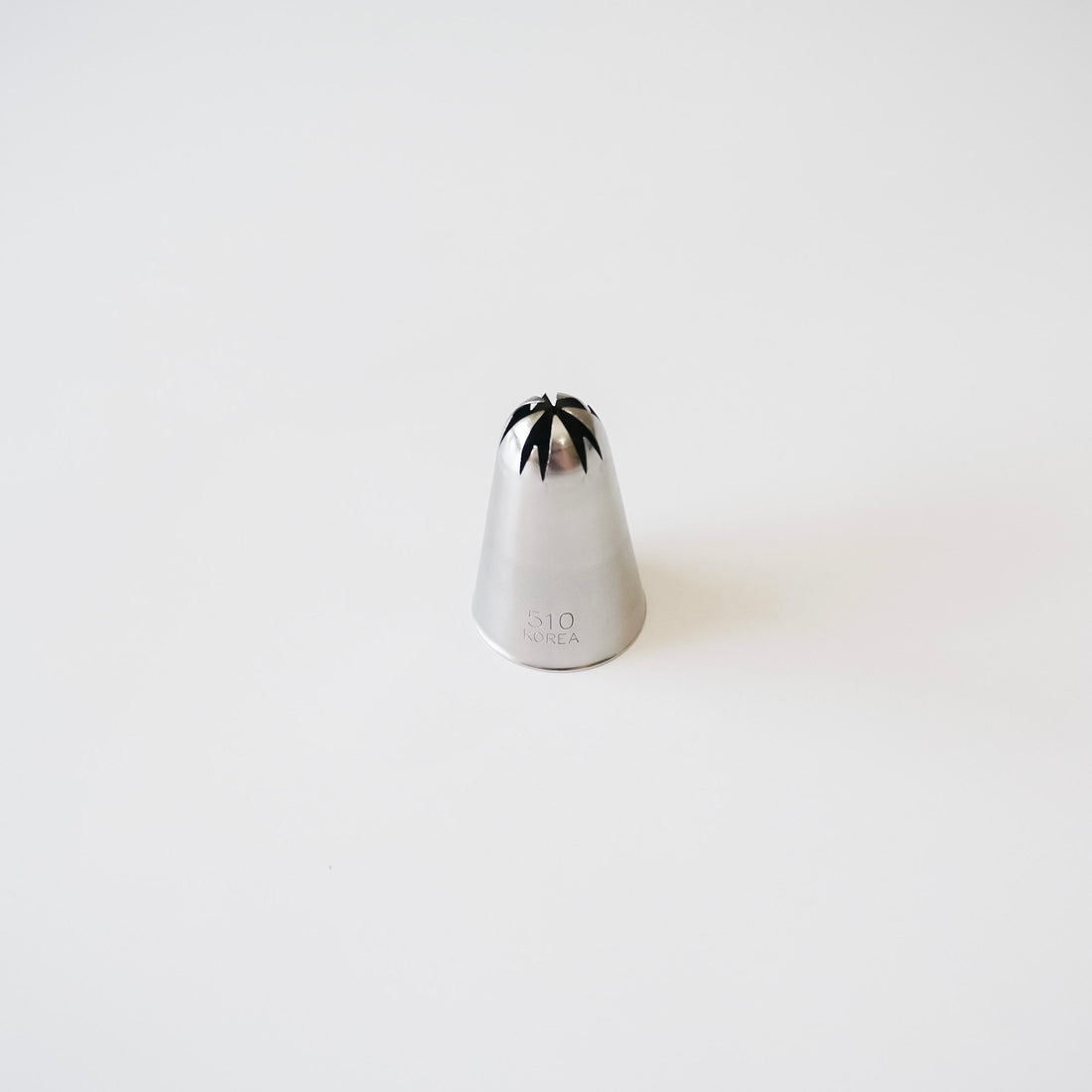 Stainless steel piping tip with closed star design on a white background