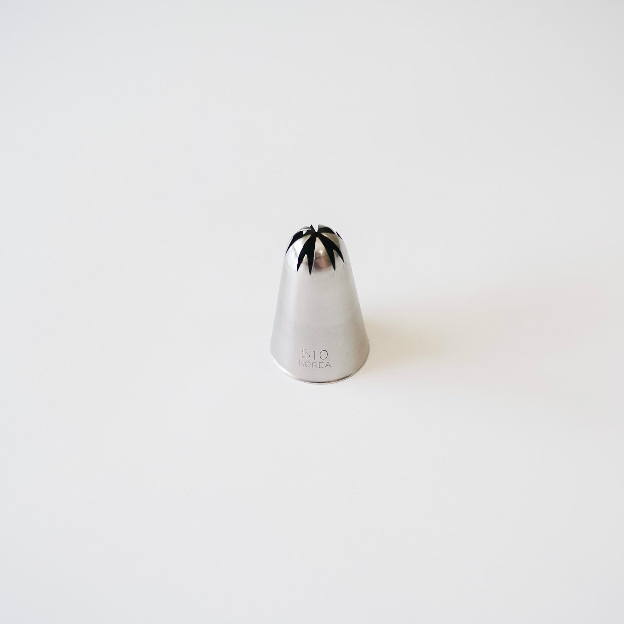 Stainless steel piping tip with closed star design on a white background