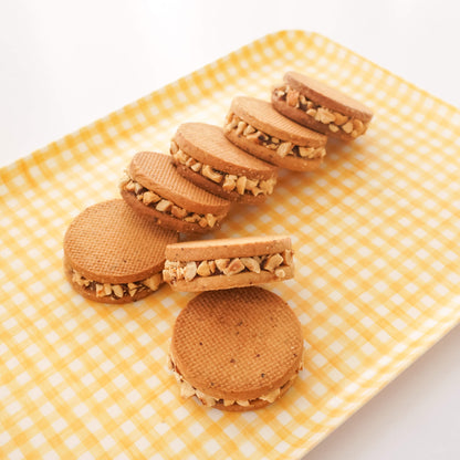 Cookies with walnut filling on a yellow checkered plate