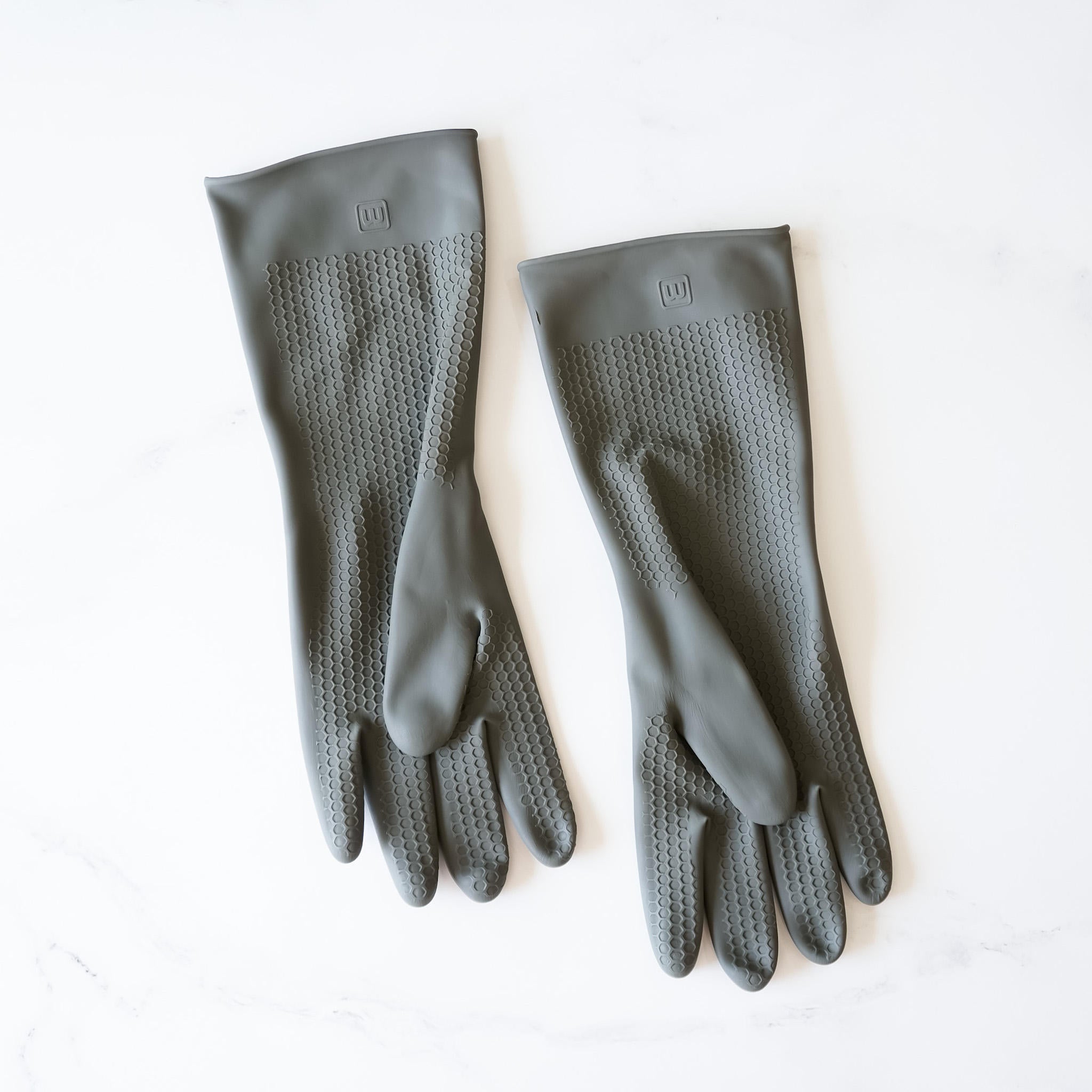 Two pairs of gray rubber gloves. One pair has a textured surface and the other pair is smooth. 