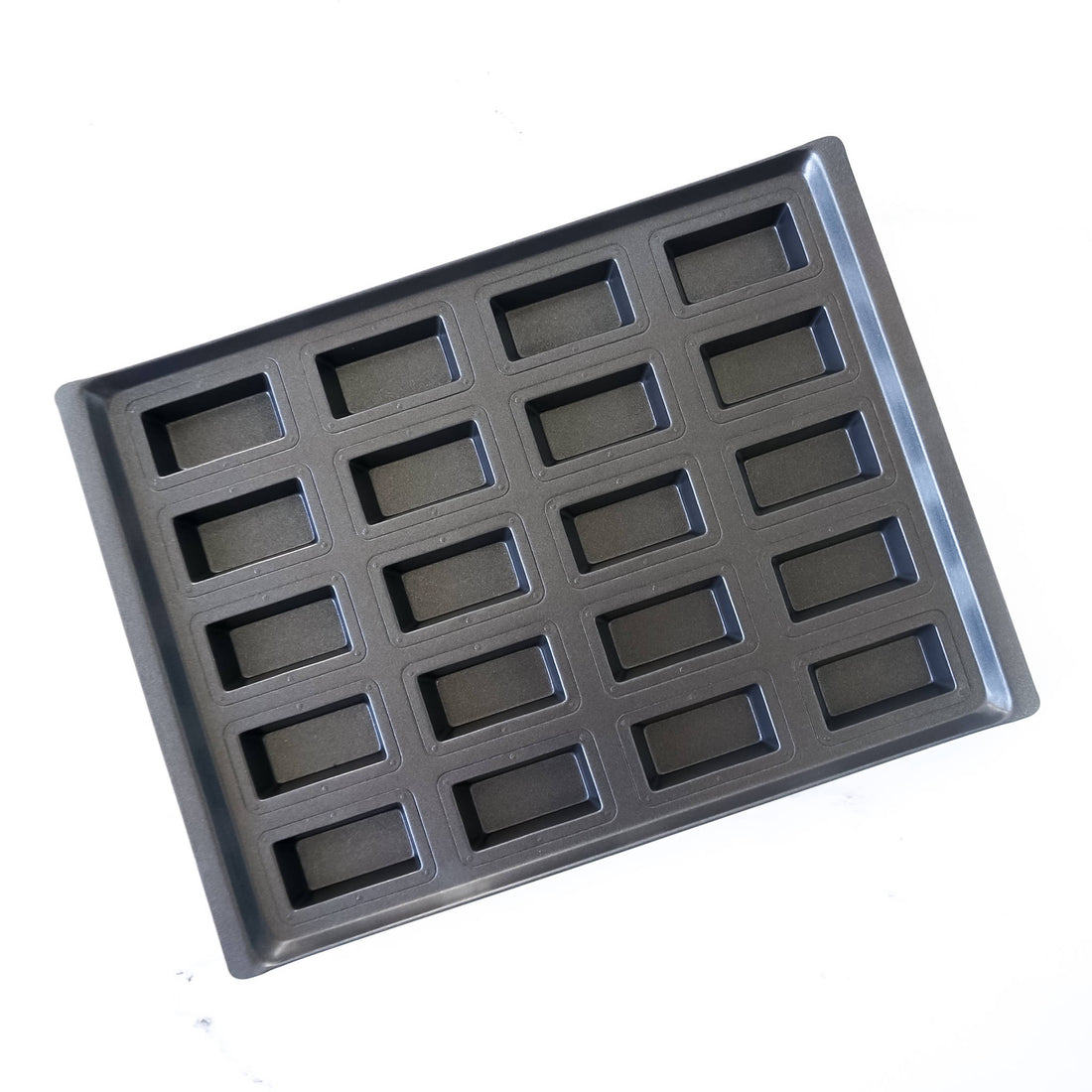 Black deep financier cake pan with multiple compartments on a white background