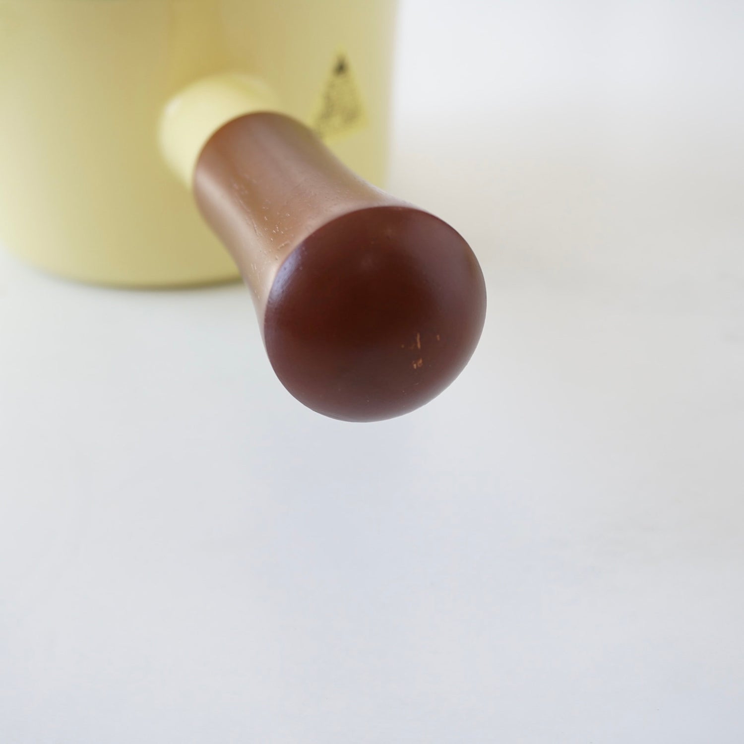 Close-up of a wooden handle on a white background
