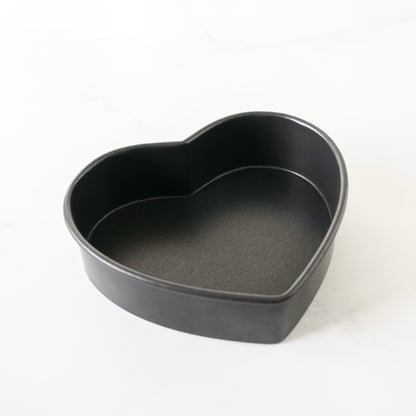 Heart-shaped black baking pan on a white background