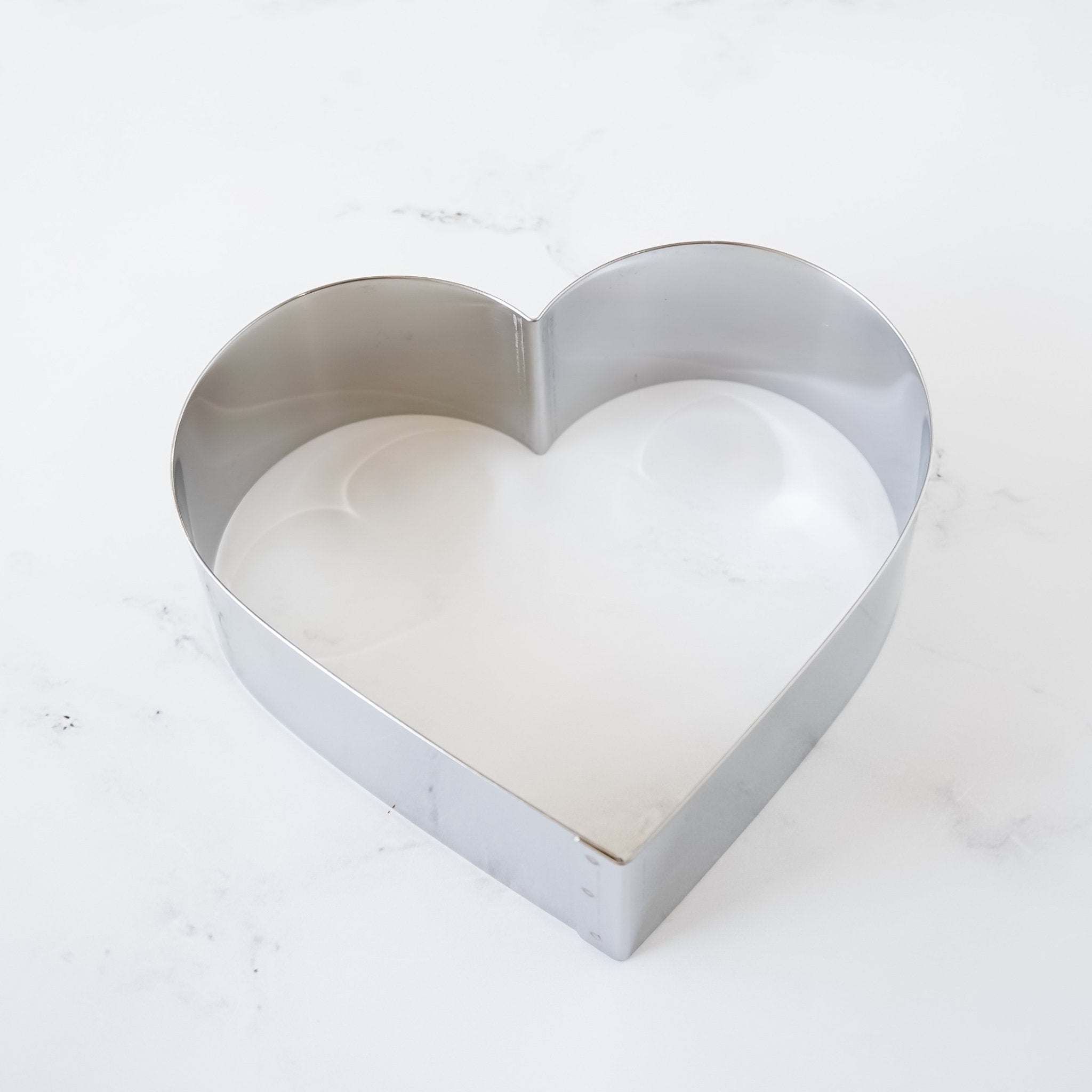 A silver heart-shaped cake pan