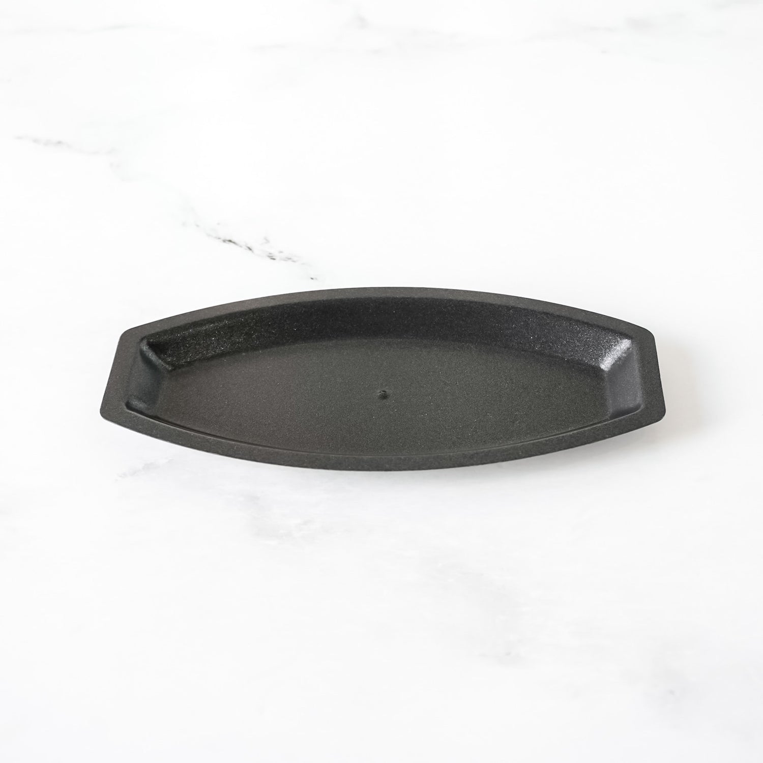 Black salt bread mold on a white background