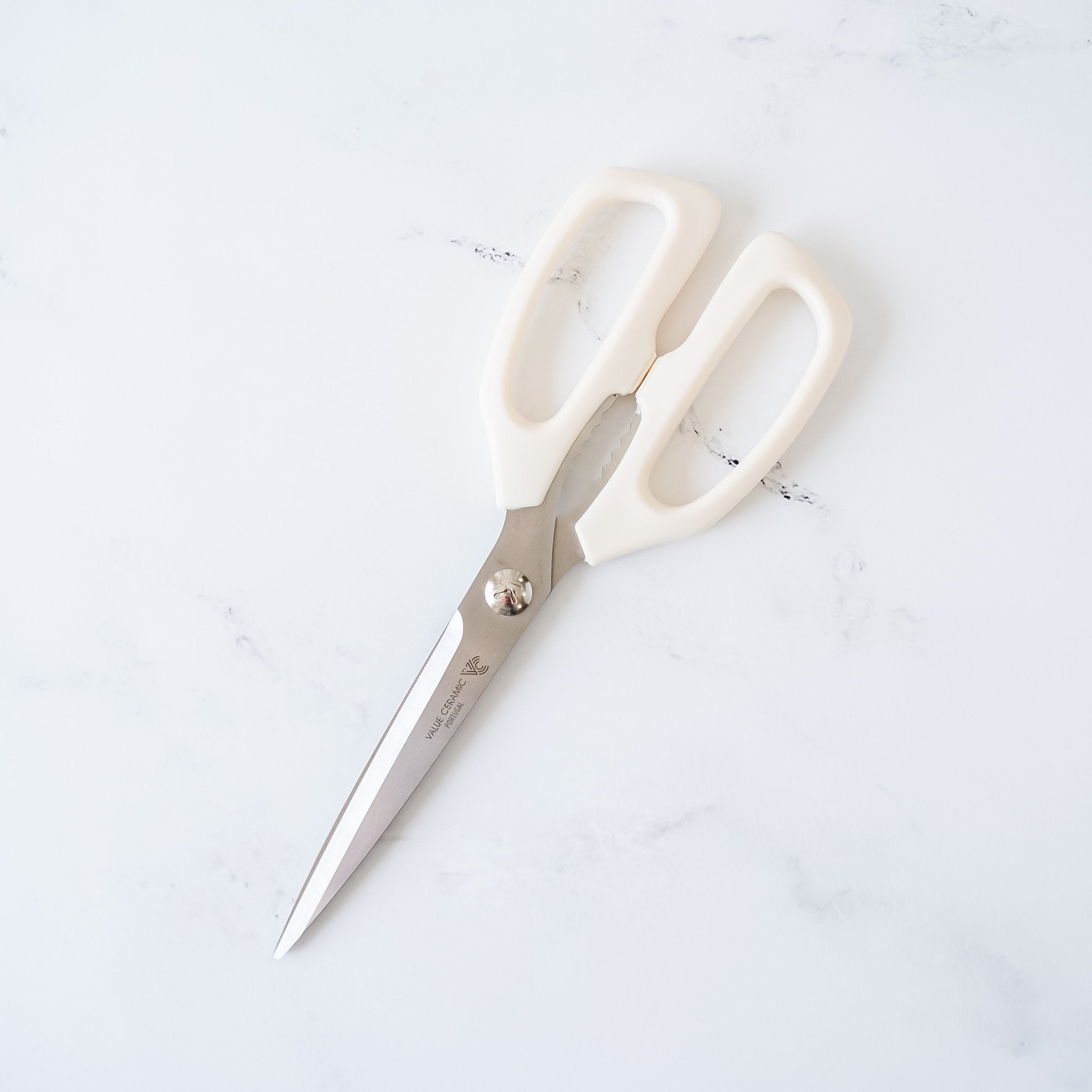 White kitchen shears with stainless steel blades. 