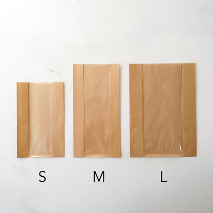 Three brown paper bags labeled S, M, and L on a white background