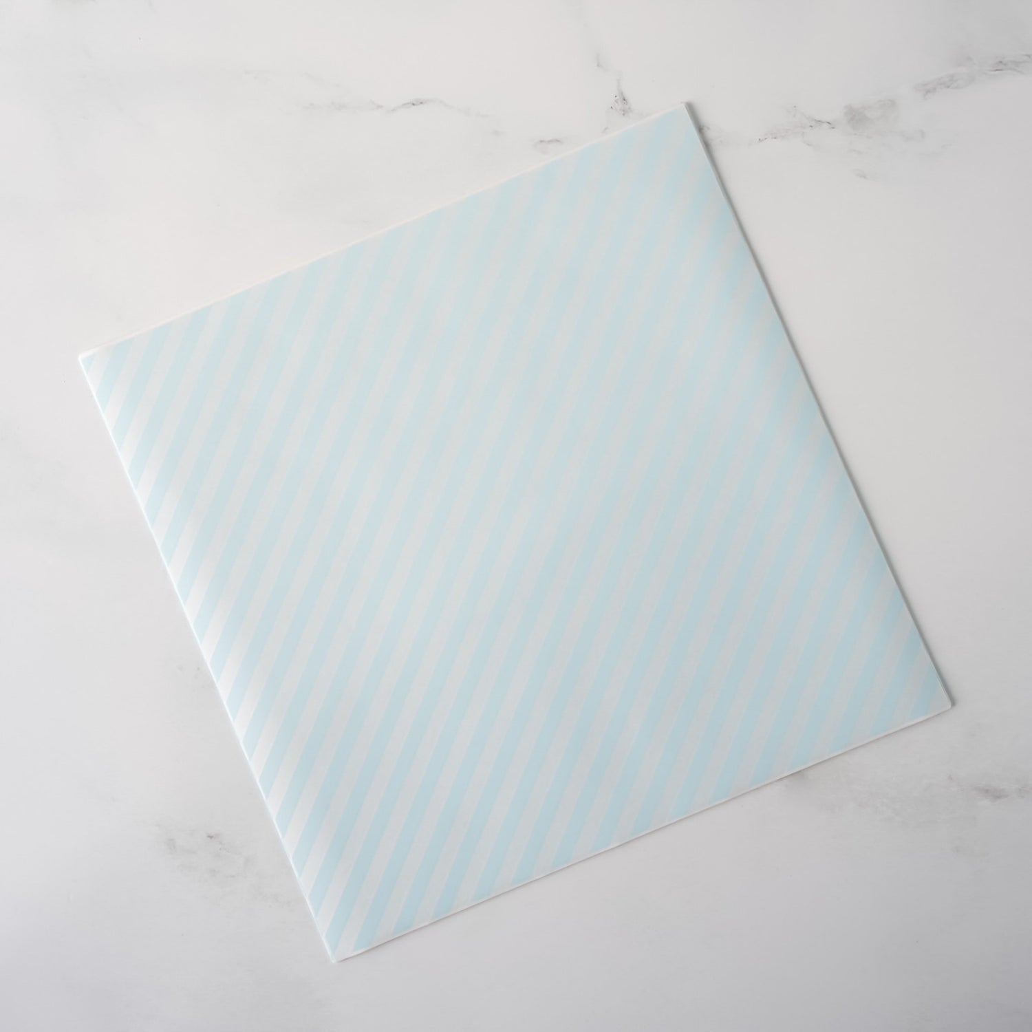 Light blue patterned deli paper on a white marble surface