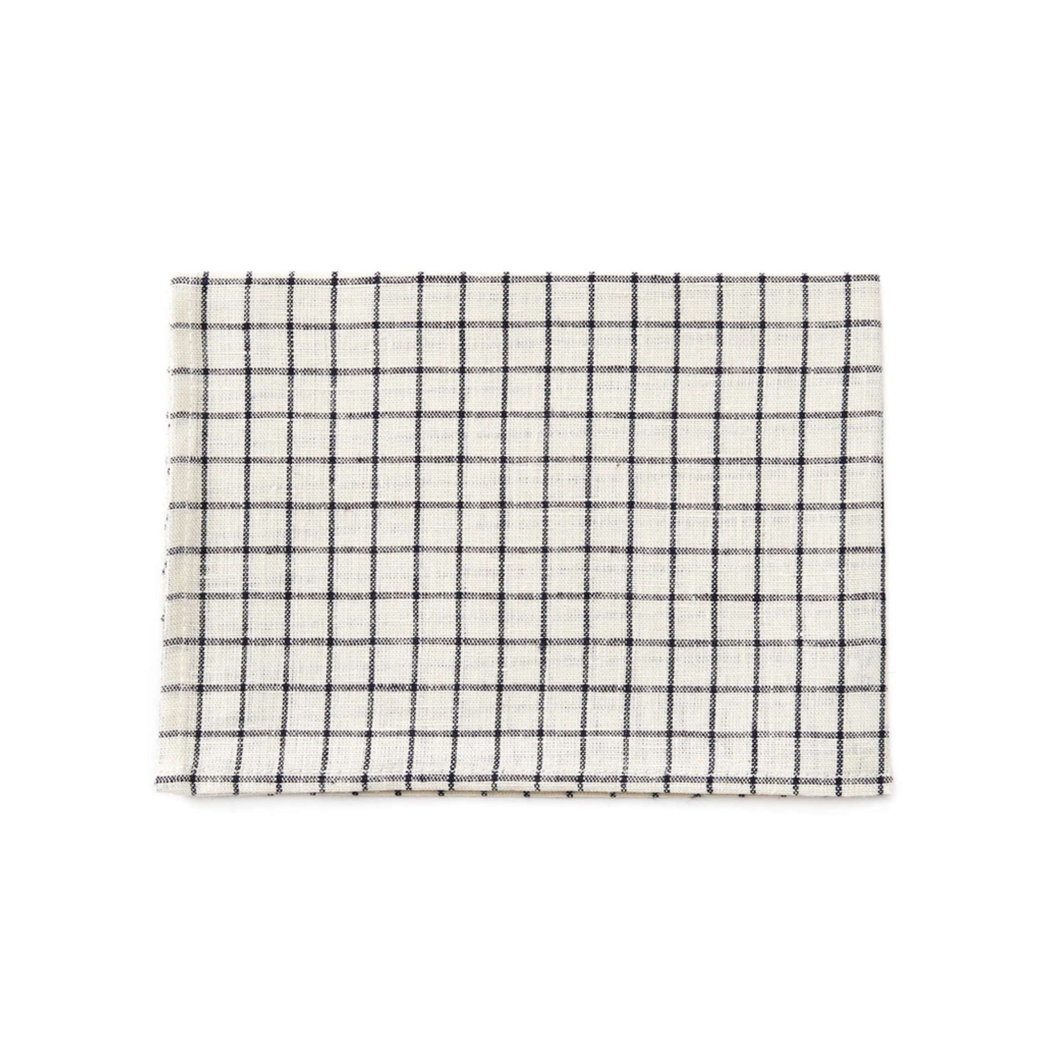 A linen dishcloth with a black grid pattern on a white background, folded neatly.