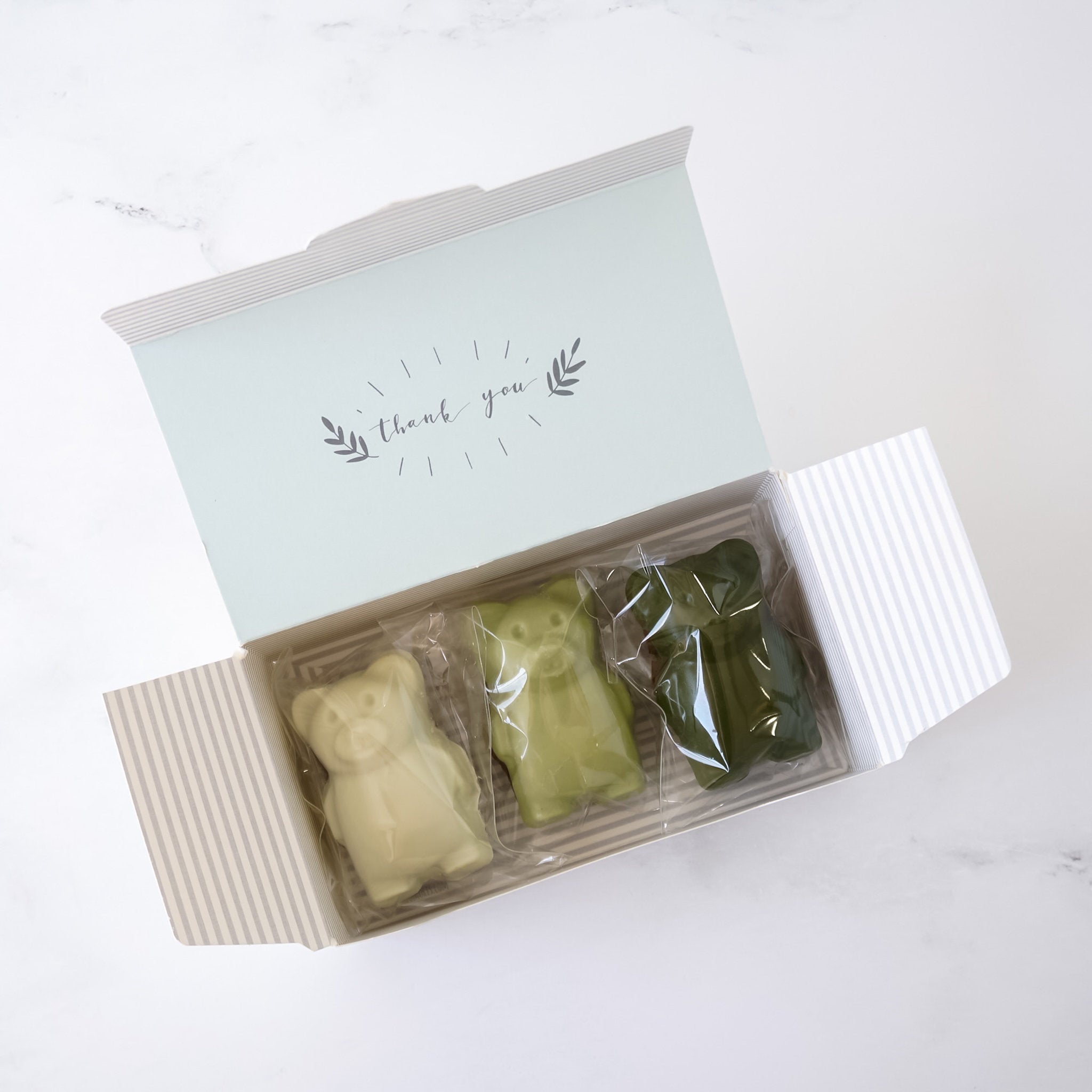 bakery box with three bear madeleines labeled &