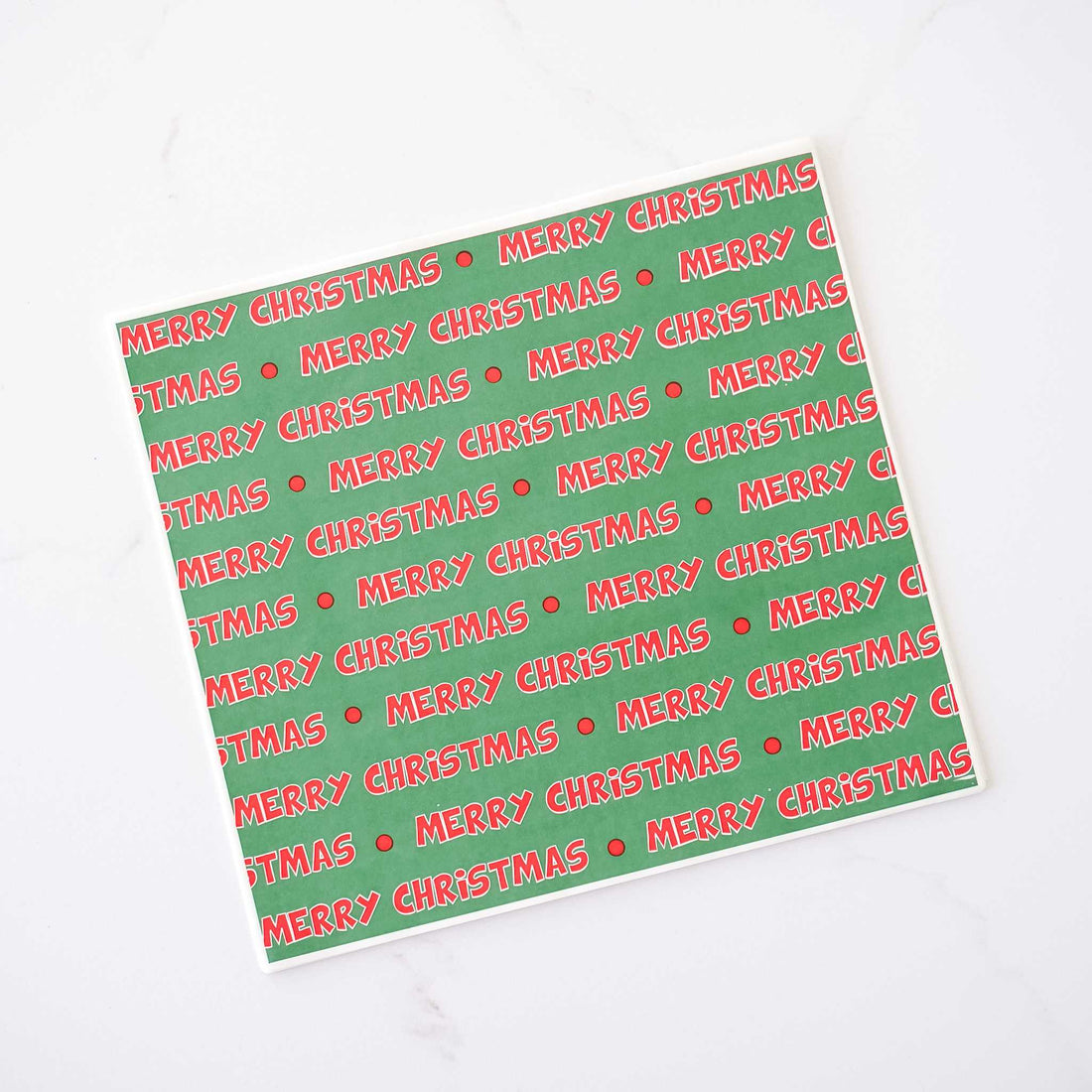 A sheet of deli paper with a green background and &