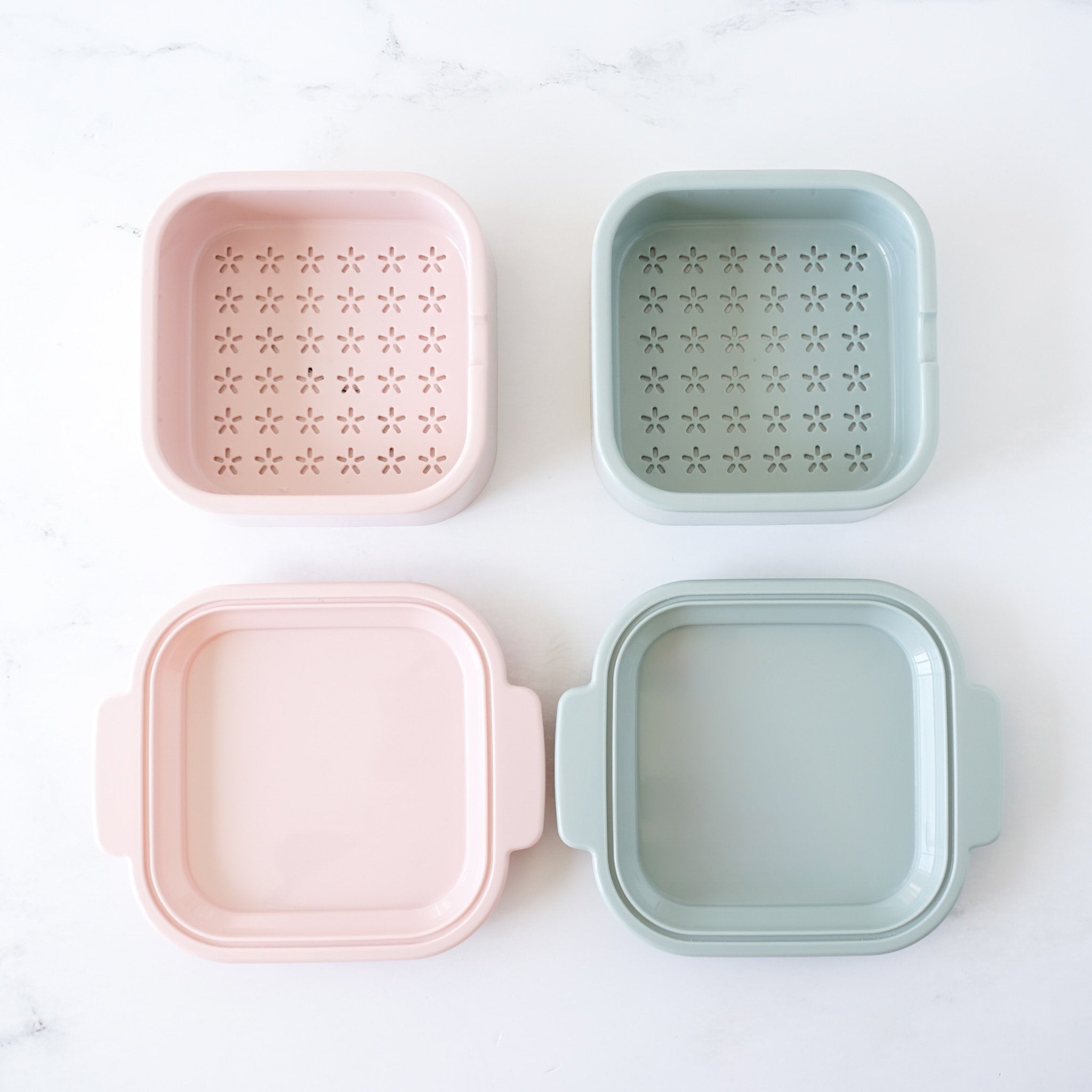 Two pink and two green square containers with star patterns on a white background