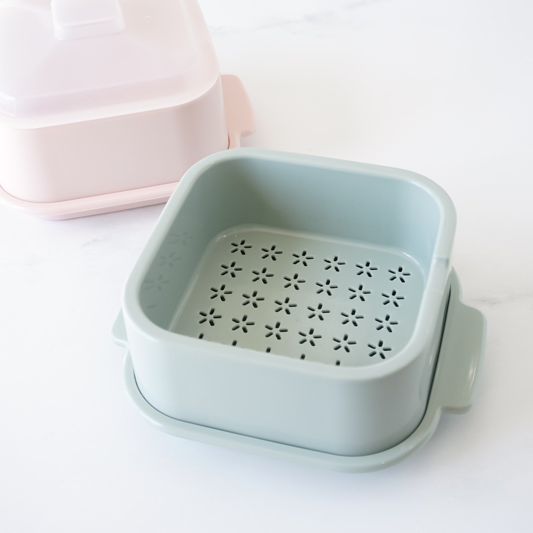 Light blue microwave steamer with floral pattern on a white background