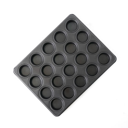 Black muffin pan with multiple compartments on a white background