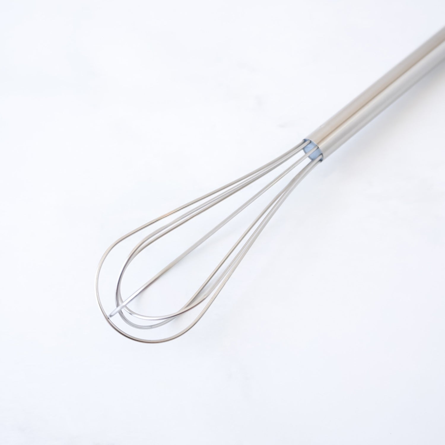Mini whisk on a white background