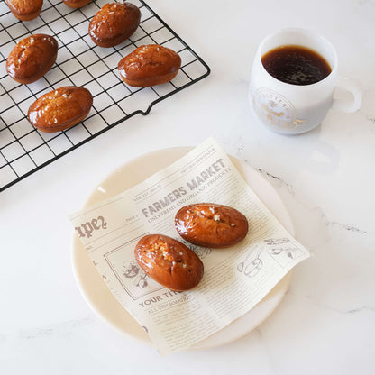 caramel financier cake on newspaper print deli paper