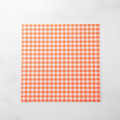 Orange and white checkered deli paper on a light gray background