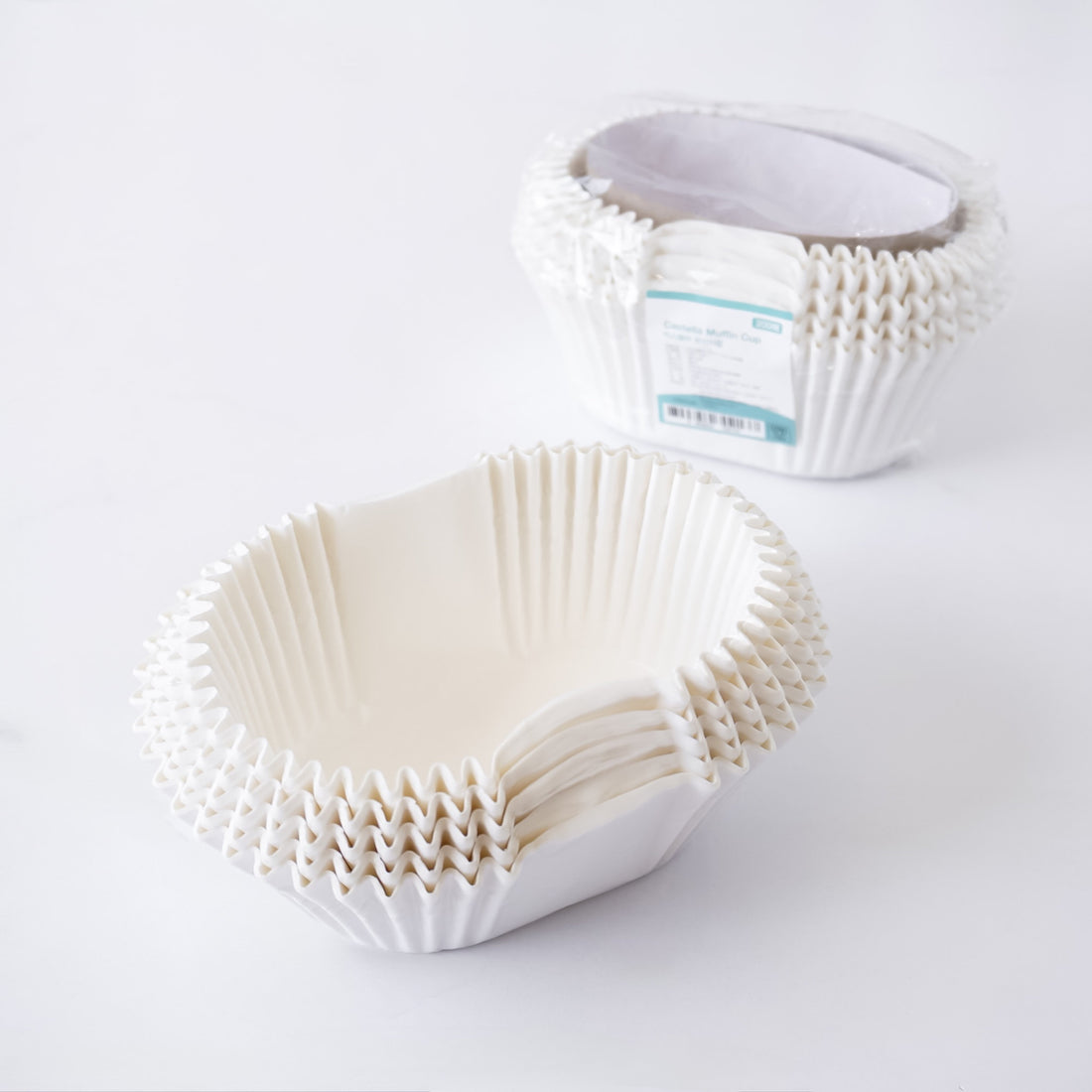 White paper cupcake liners on a white background