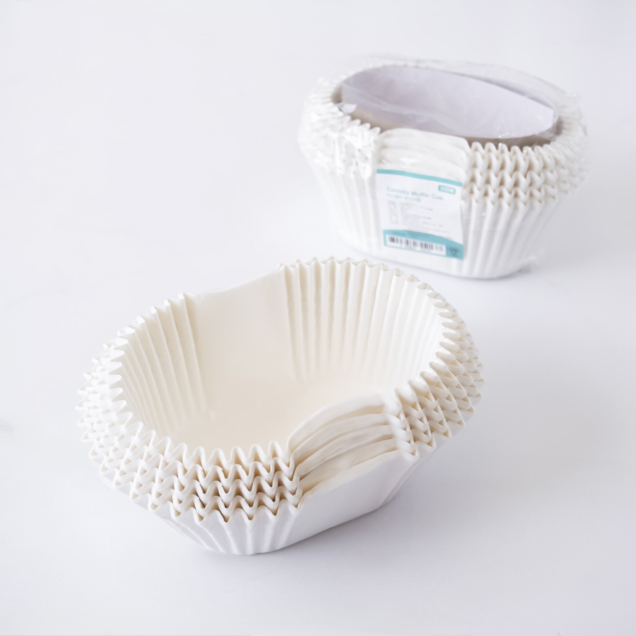 White paper cupcake liners on a white background
