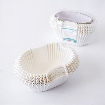 White paper cupcake liners on a white background