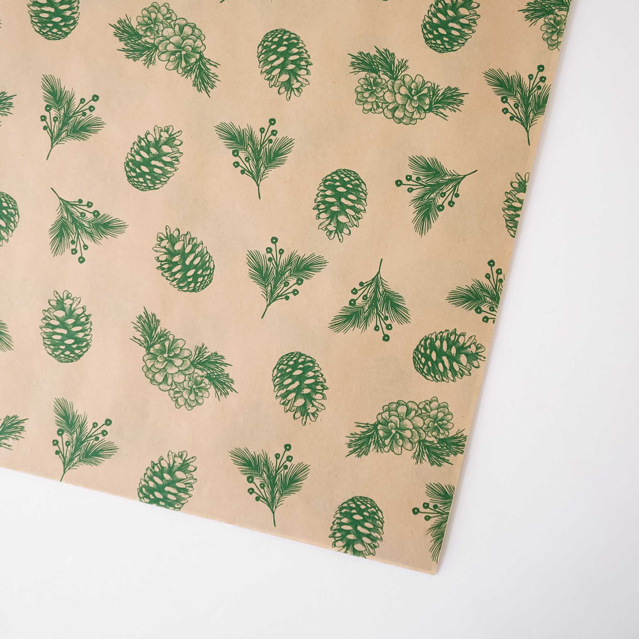 Brown paper with green pine cone and leaf pattern on a white background