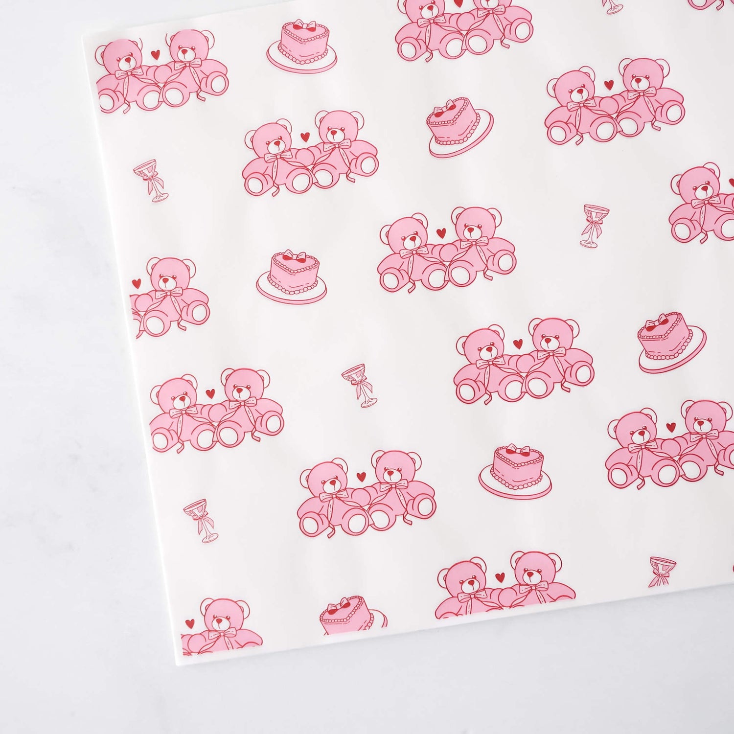 White paper with pink teddy bear and cake pattern
