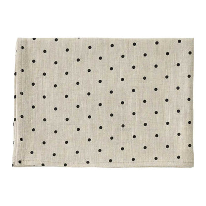 A linen dishcloth in a light beige color with a black polka dot pattern, laid flat against a white background.