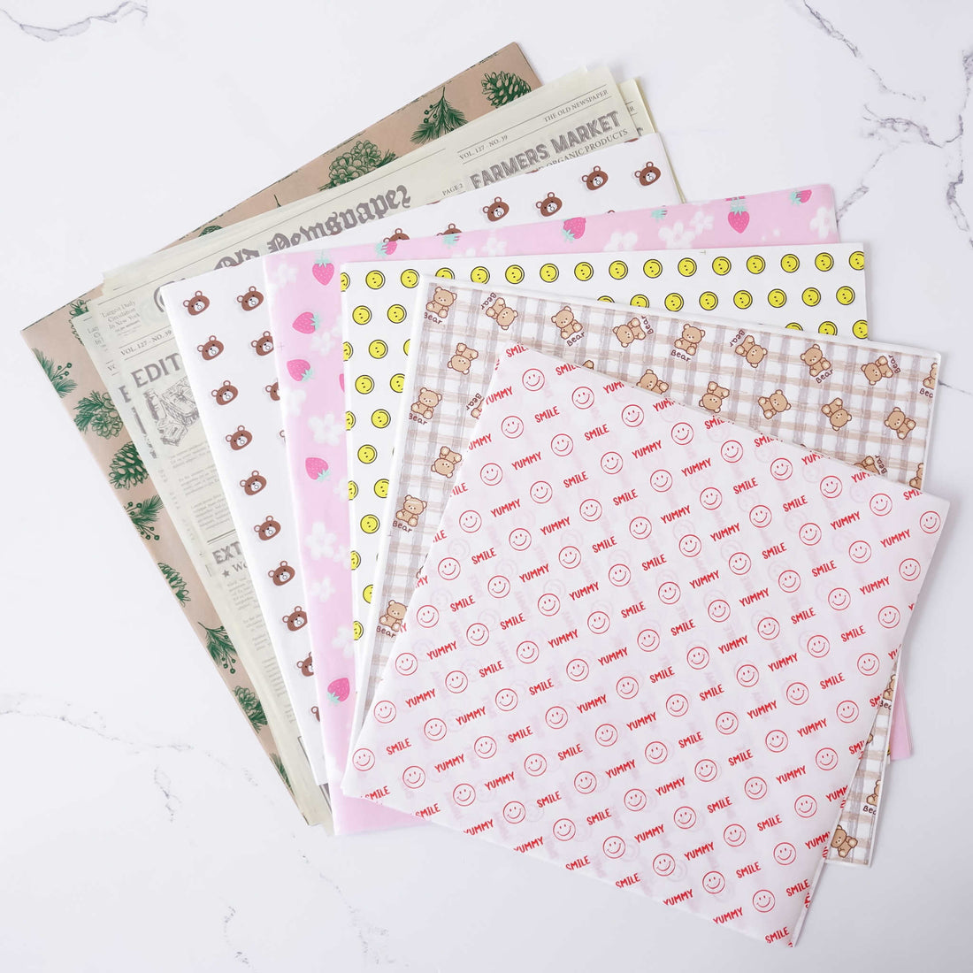 Set of patterned deli paper sheets on a white surface