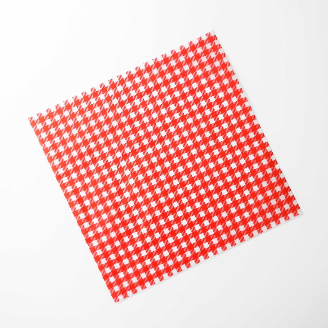 Red and white checkered deli paper on a white background
