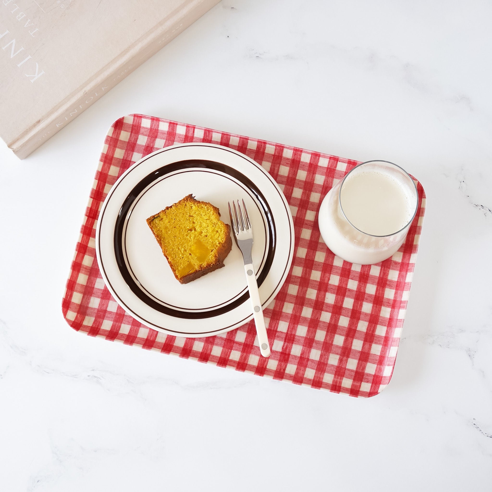 pound cake and milk on a red check serving tray