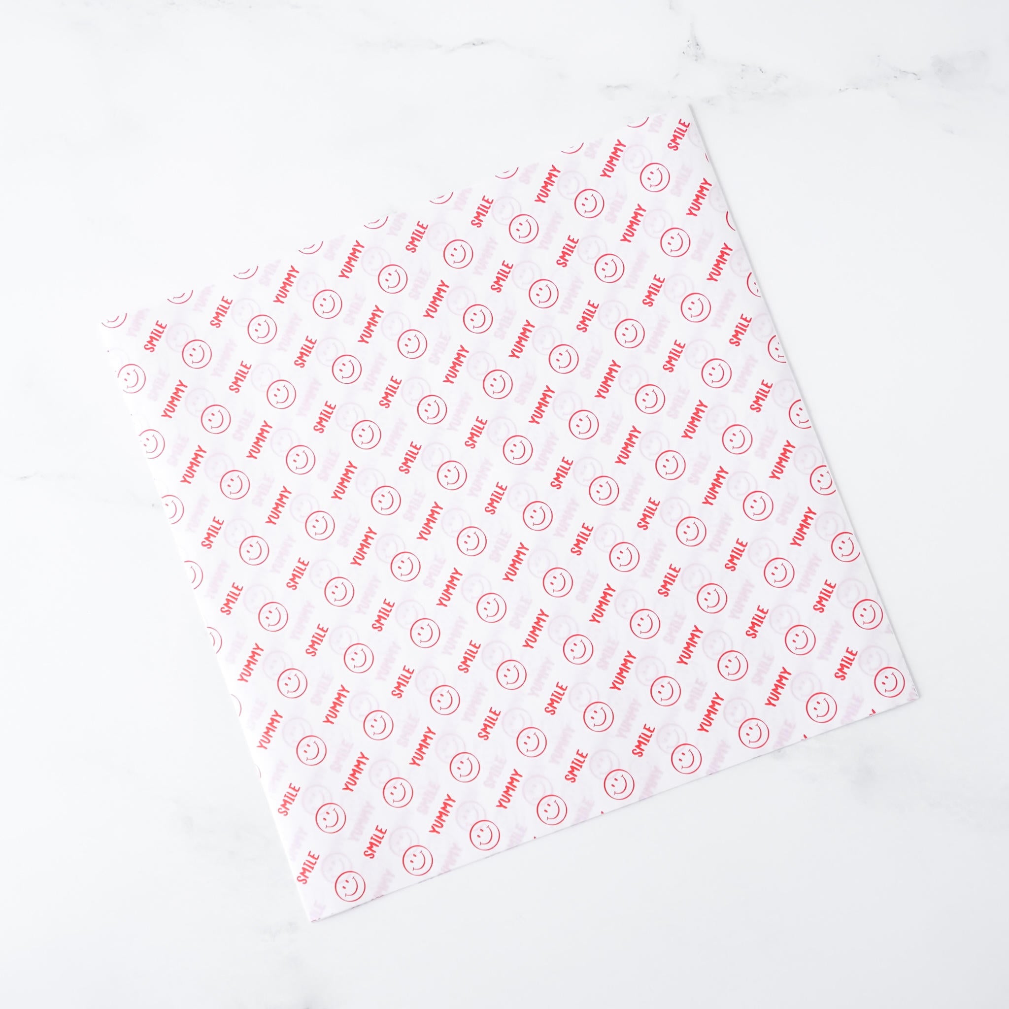 White deli paper with red text and logo on a white background