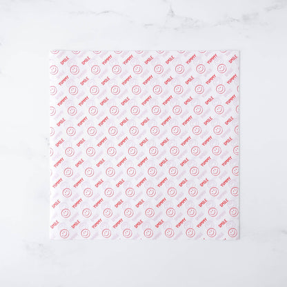 Smile patterned deli paper with red text and smiley faces on a white background