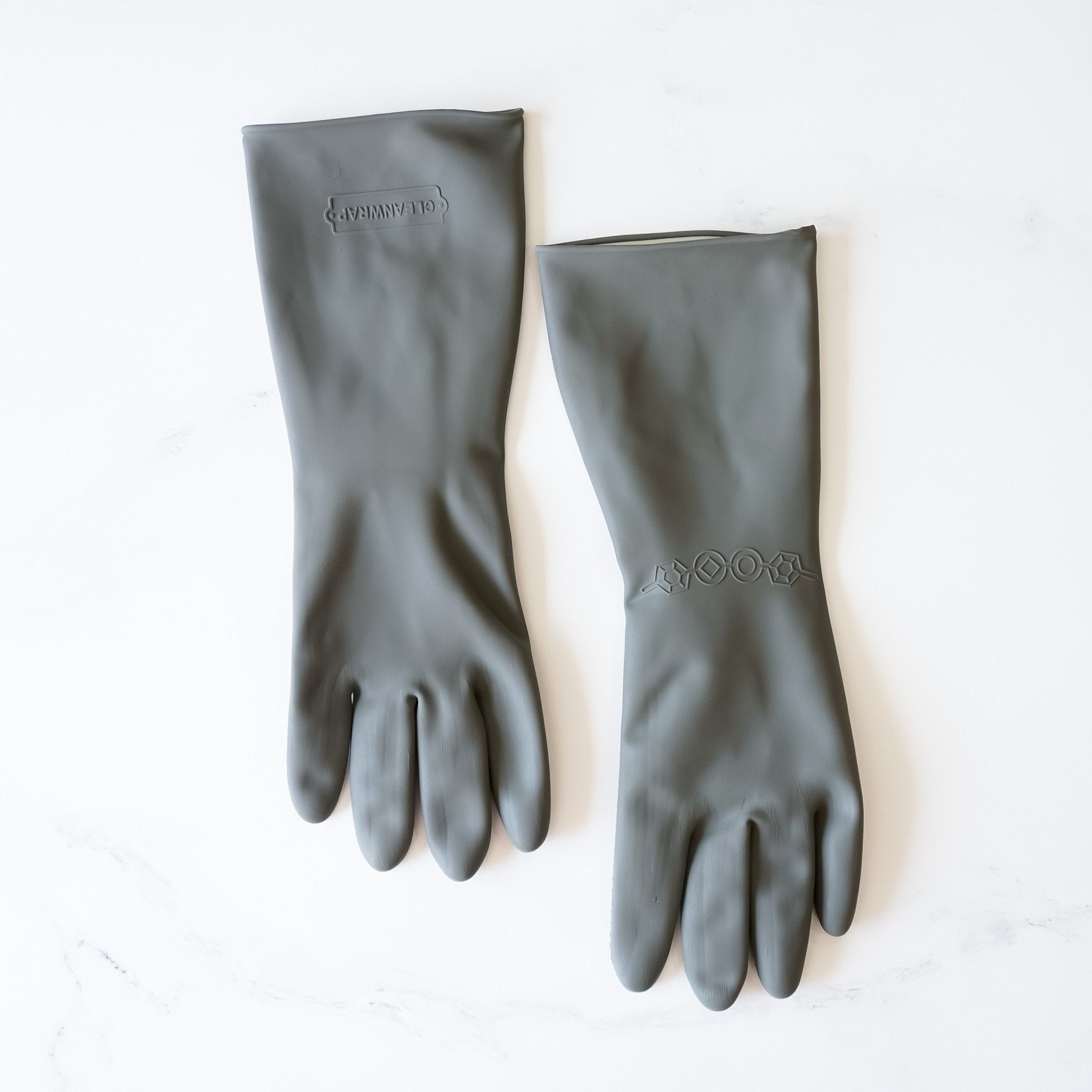 A pair of gray rubber dishwashing gloves with a honeycomb texture. The gloves have a logo on the wrist that says &