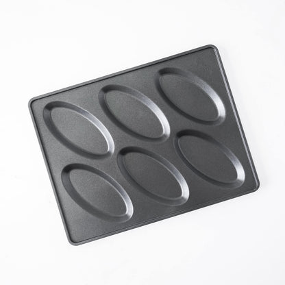 A black non-stick rectangular salt bread pan with six oval-shaped indentations, photographed from an overhead angle on a white background.