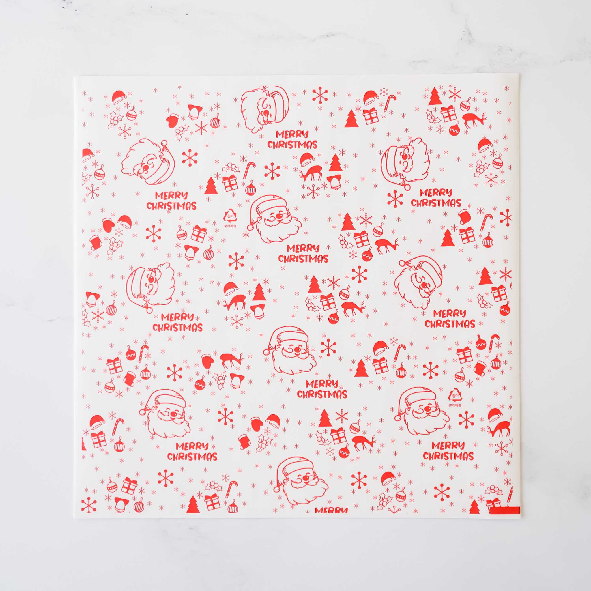 Red and white Christmas wrapping paper features a repeating pattern of Santa Claus illustrations and the phrase &