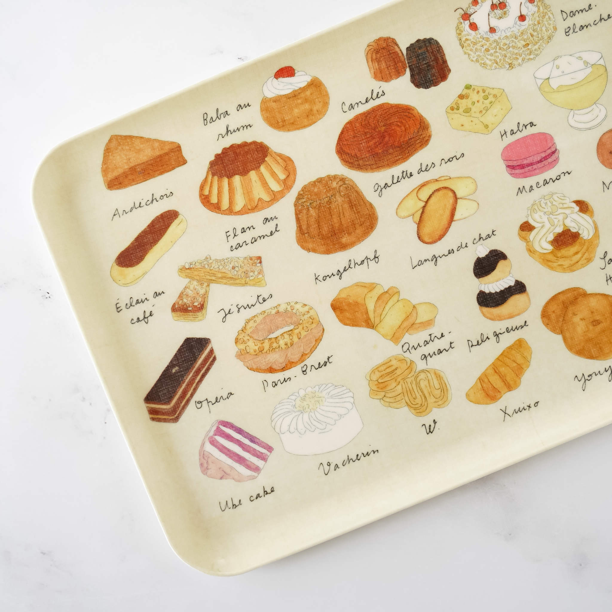 A medium-sized linen-covered serving tray with pastry-themed illustrations featuring various cakes and pastries.